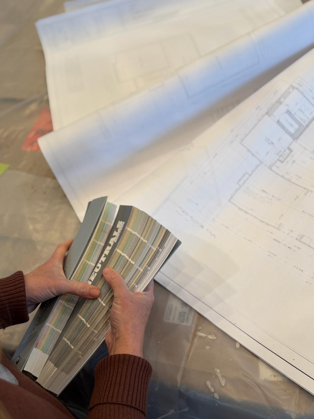 Floor plans and material samples on a table